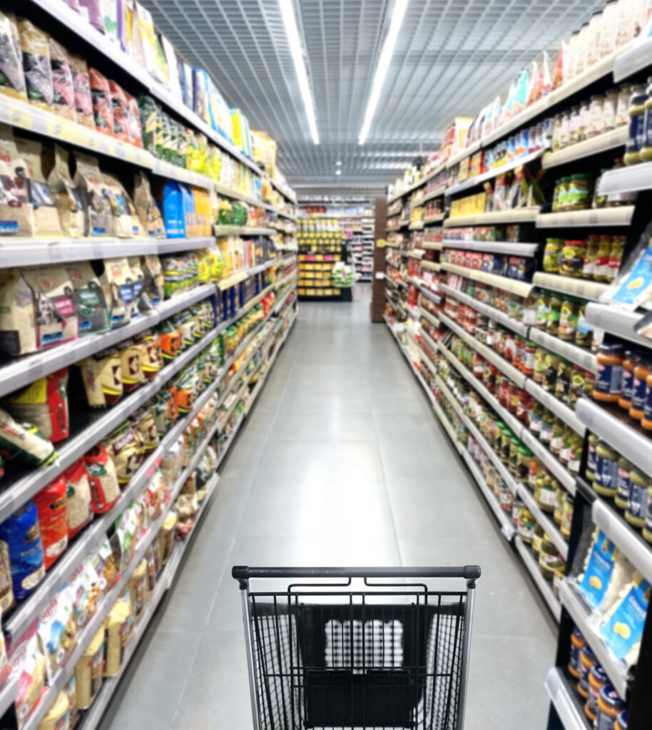 image of empty grocery cart in grocery store aisle